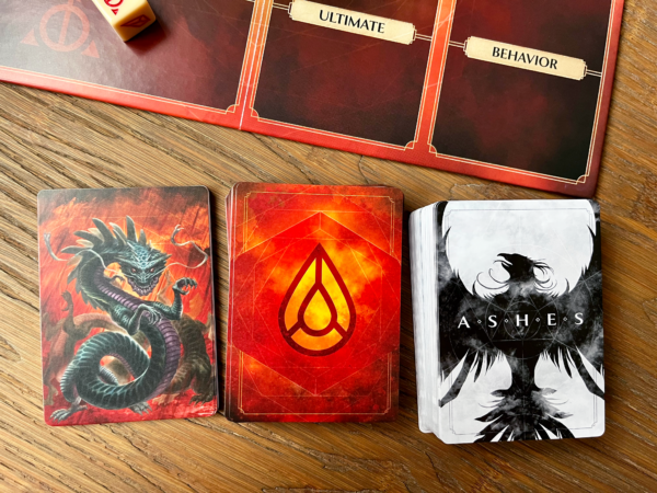 Card backs for the cards included in theAshes Reborn: Red Rains - Corpse of Viros box with the Chimera board above