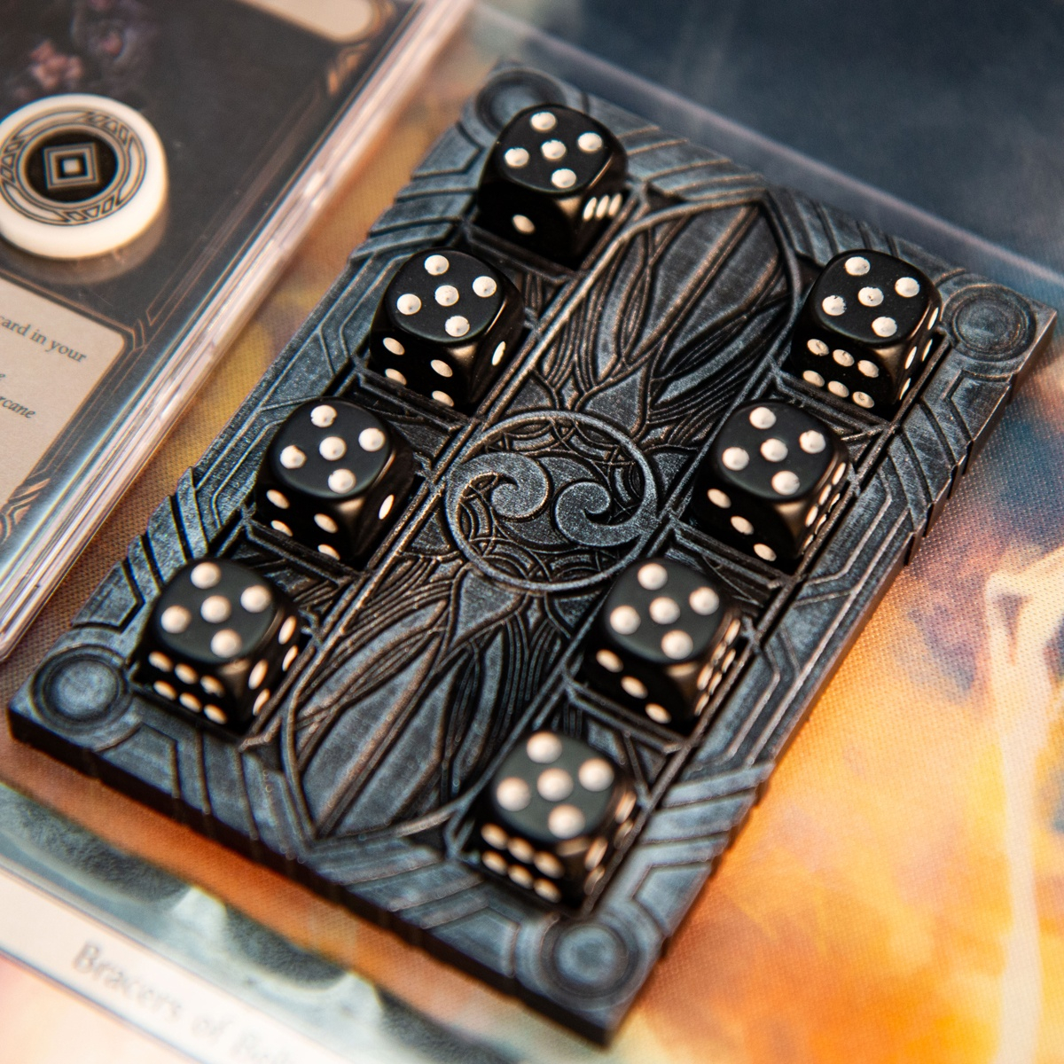 Majestic Dice Board - Battleworn Edition full of dice and next to a Flesh and Blood TCG card with an Activation Token on top of it
