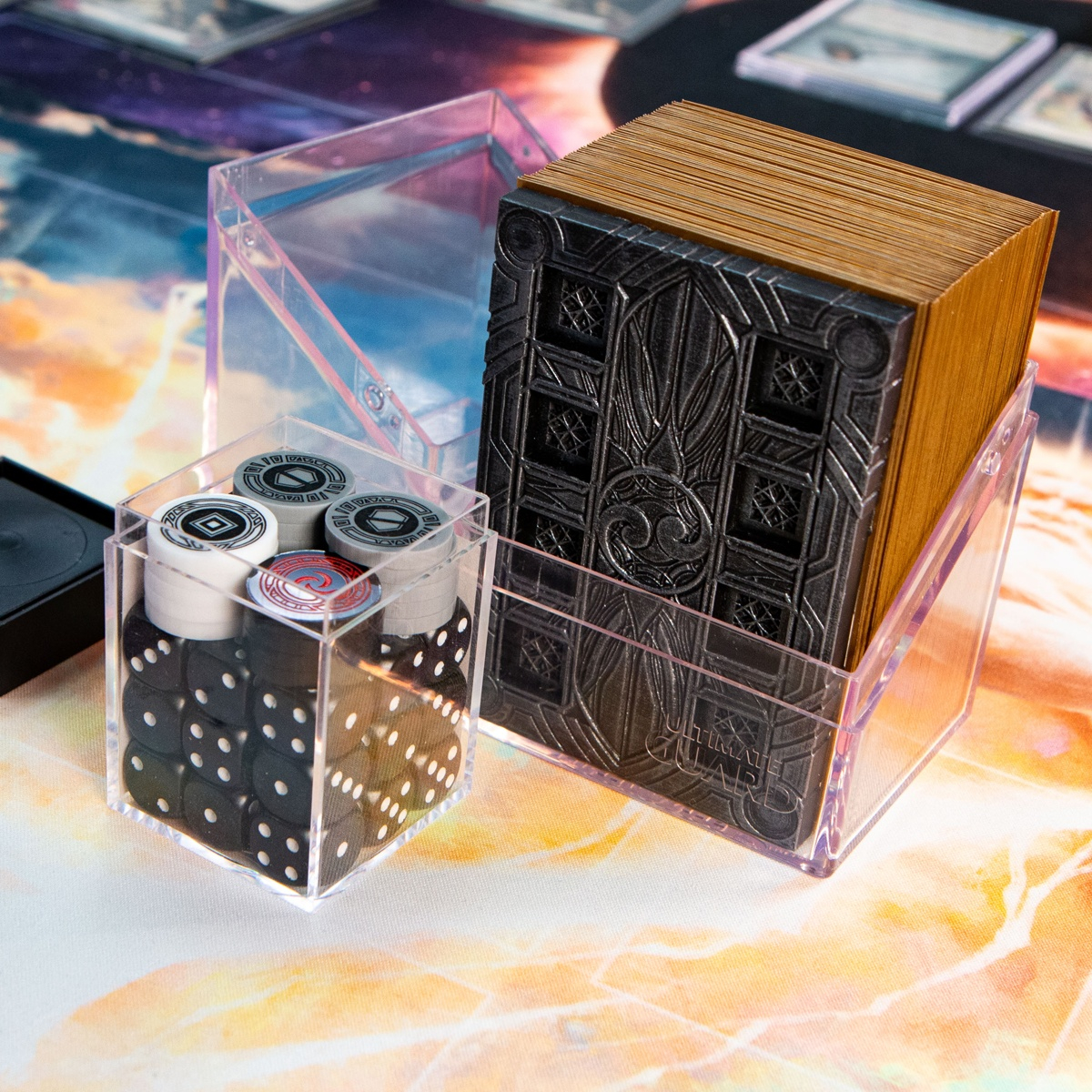 Side view of a 12mm dice set containing all the tokens from the Majestic Token Set as well as a transparent deck box containing a Majestic Dice Board - Battleworn Edition