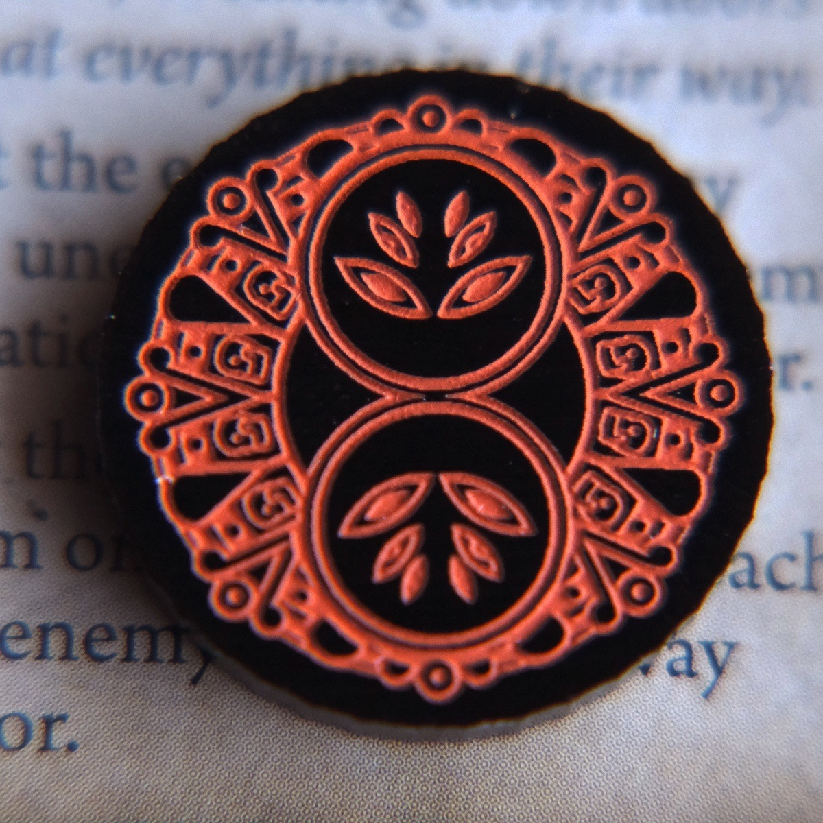 Close up of the two-value side of the Forgotten Limited Edition Doom Token highlighting the Ancient South American inspired design