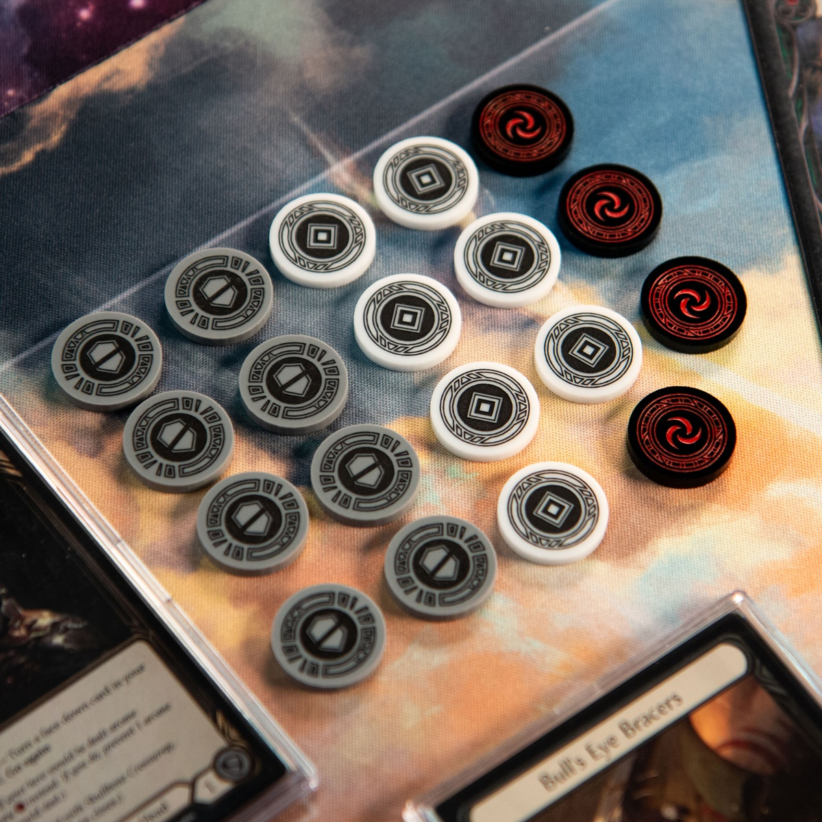 Eight Armor Tokens, seven Activation Tokens, and four Resource tokens laid out on a playmat, surrounded by cards from the Flesh and Blood TCG