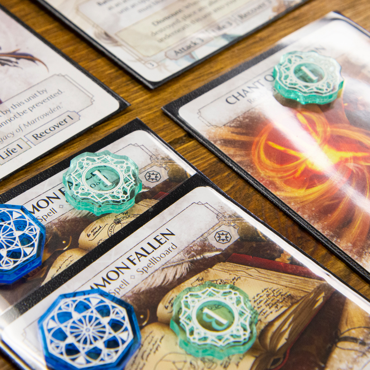 Close up of the Exhaustion and Status tokens from the Arcane Token Set as they might look in a game of Ashes: Reborn