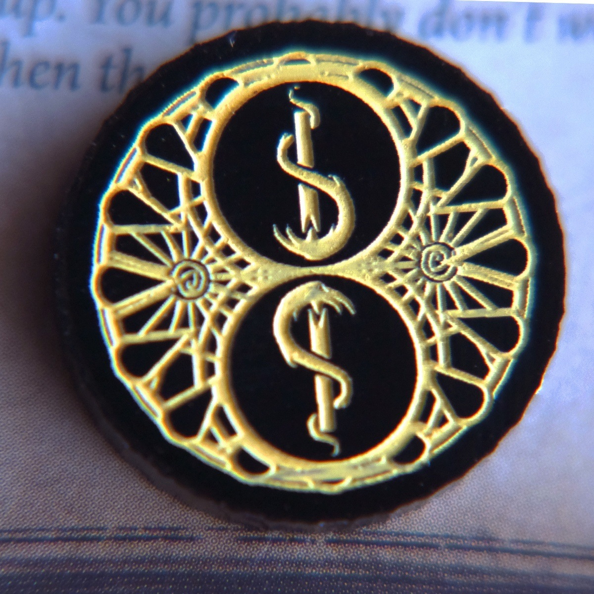Close up of the two-value side of the Carcosa Limited Edition Doom Token highlighting the inverted torch motif