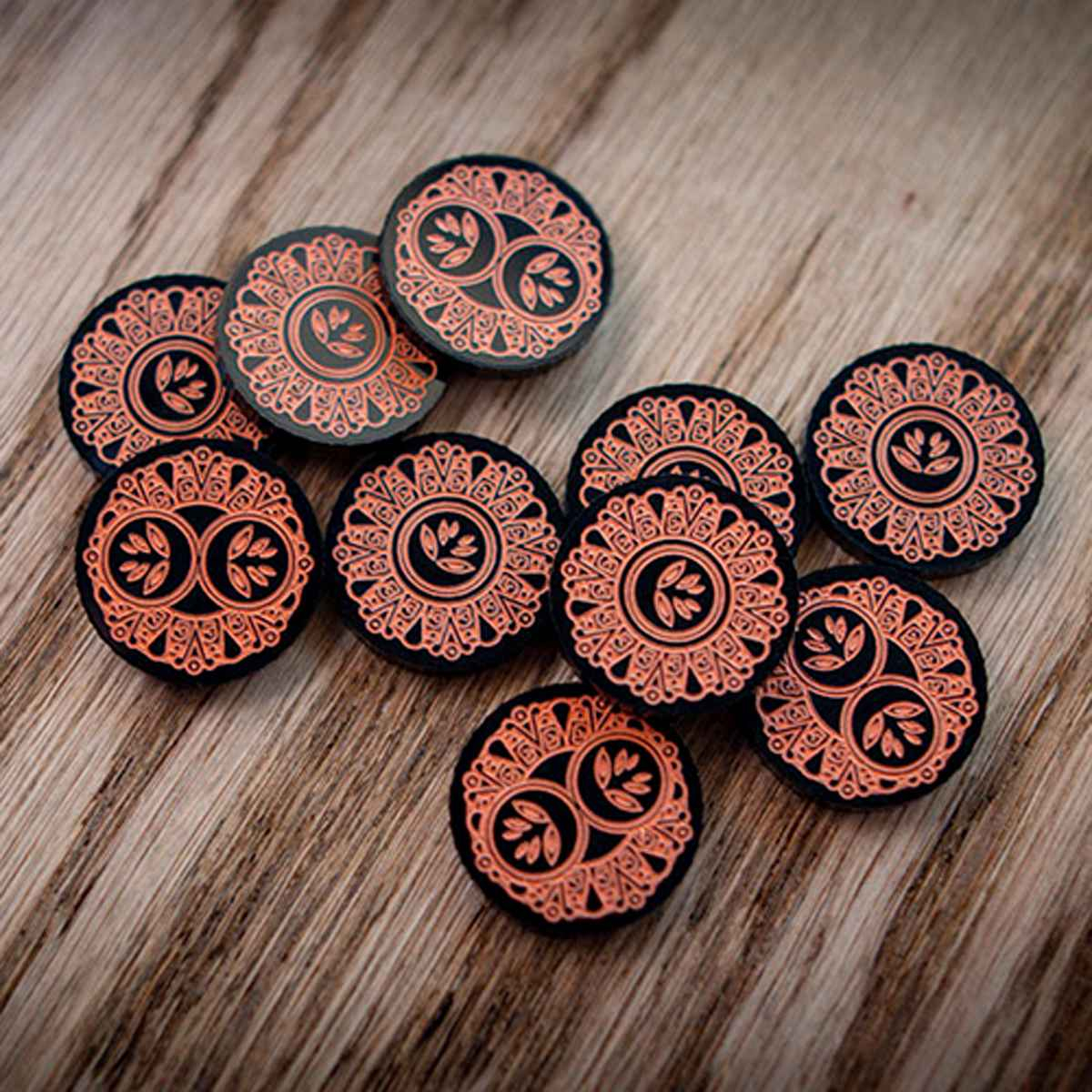 A jumble of Forgotten Limited Edition Doom tokens displaying the one-value and two-value side on top of a wooden table