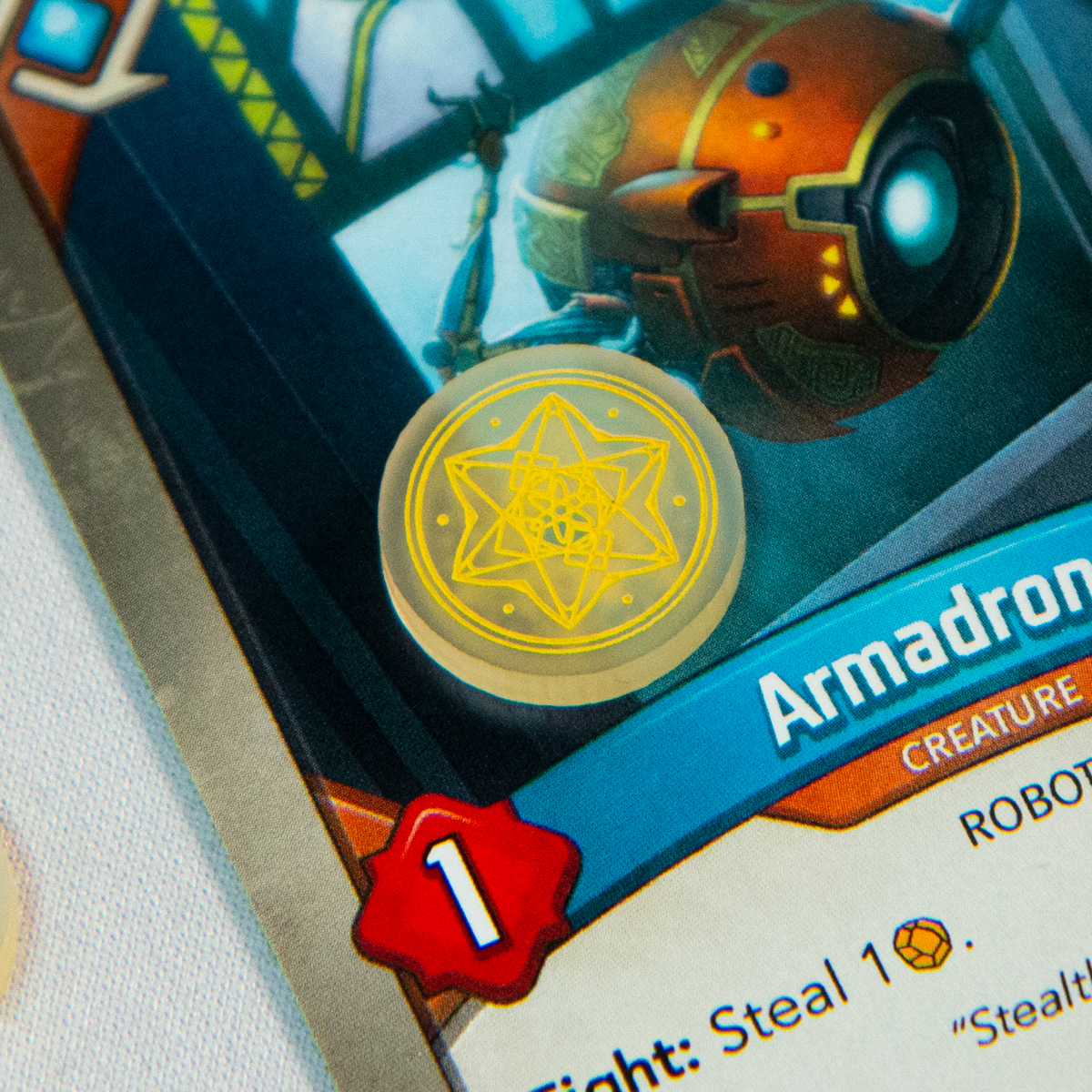 Close up of a Bitter Winds Amber Token on the Armadrone card from Keyforge