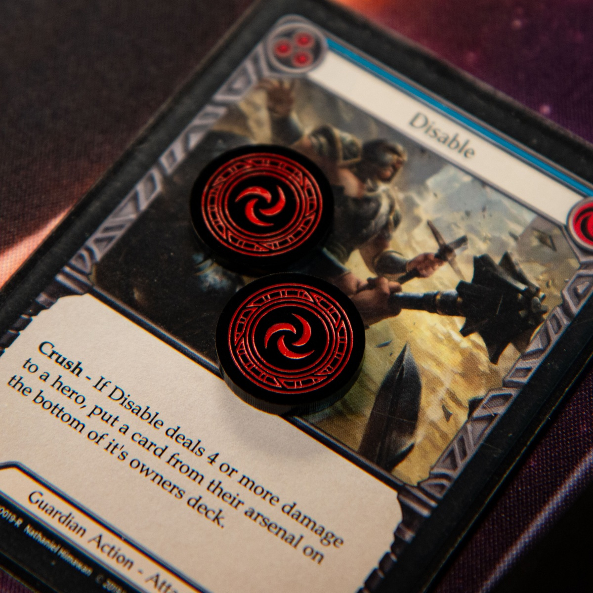 Two Resource Tokens from the Majestic Token Set on the Flesh and Blood TCG card, Disable (Blue)