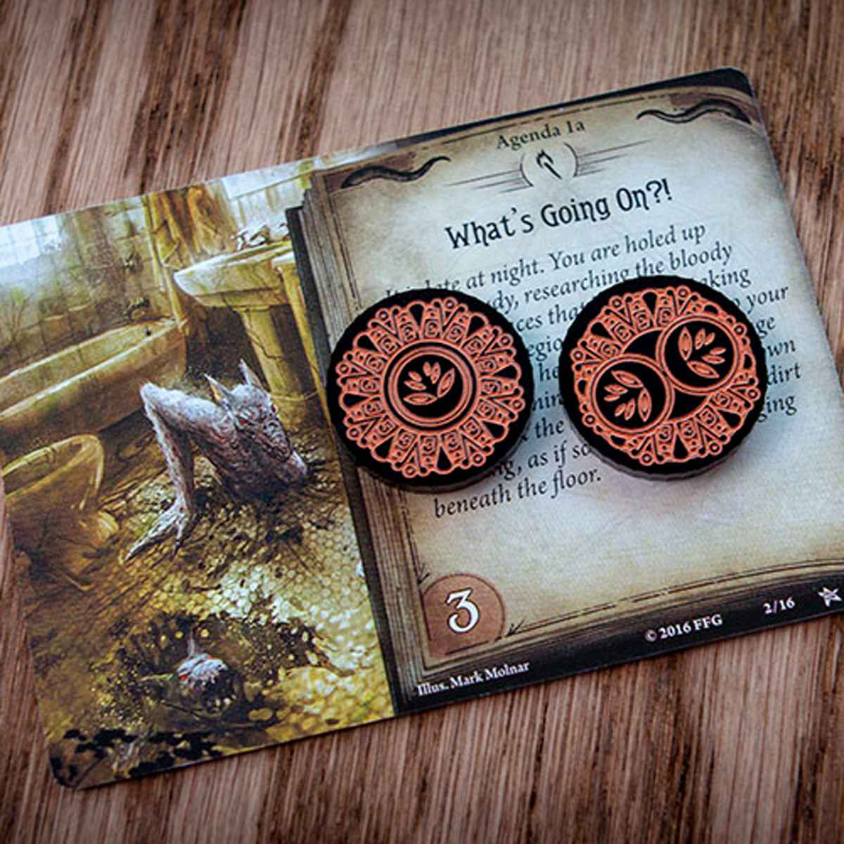 The one-value side and the two-value side of the Forgotten Limited Edition Doom Token represented by two different tokens on top of the Arkham Horror LCG agenda, What’s Going On