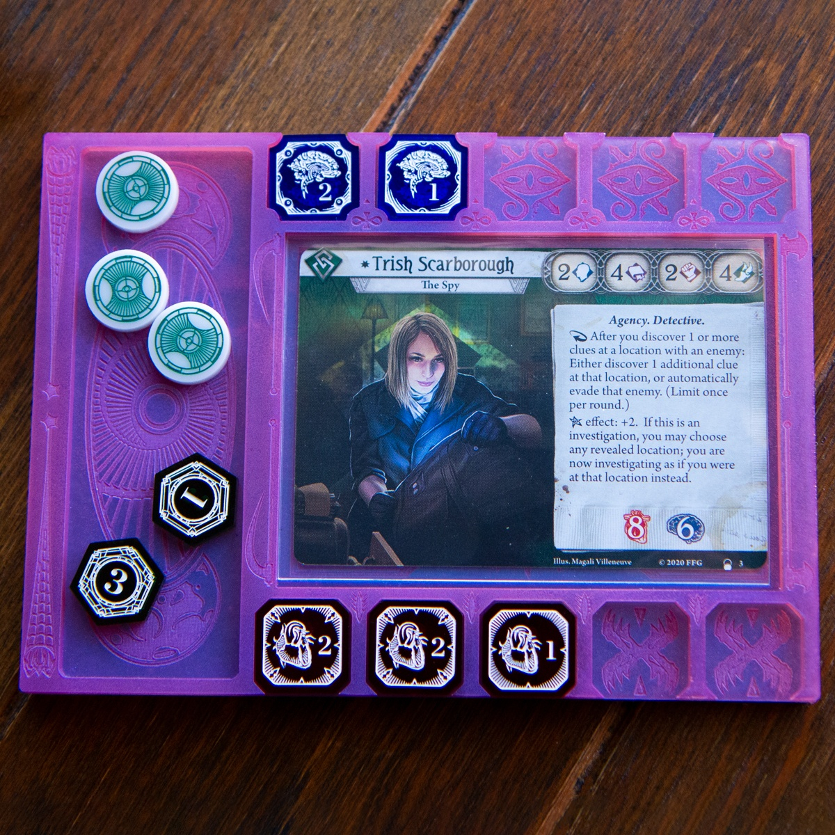 Dream Mythos Board at a neutral angle with the Clue/Resource holder on the left side demonstrating its usability in both right and left handed positions.  A few tokens from the Investigator Mythos Set are slotted in there places and the Arkham Horror LCG investigator, Trish Scarborough is resting in the card holder section