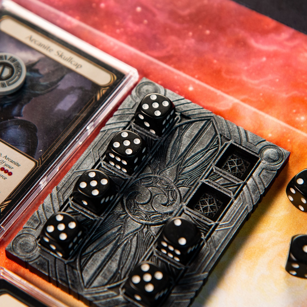 Majestic Dice Board - Battleworn Edition brightly lit and with to dice removed next to the Flesh and Blood TCG card Arcanite Skullcap