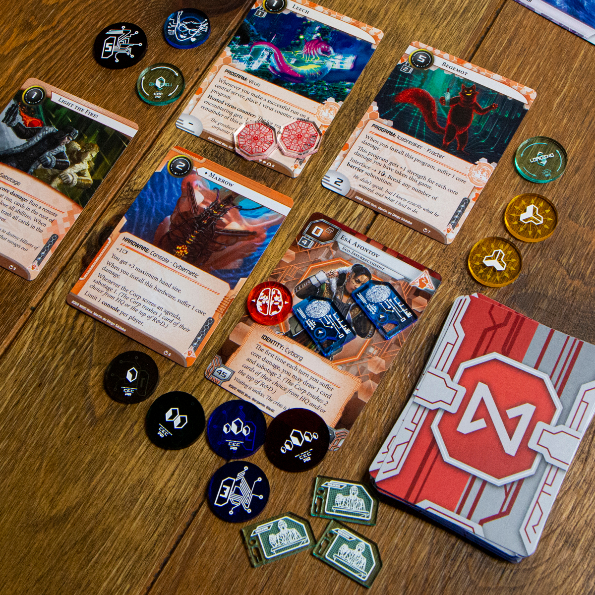 All designs from the Data Token set displayed on top of a sample Anarch play zone from Null Signal Games version of Netrunner