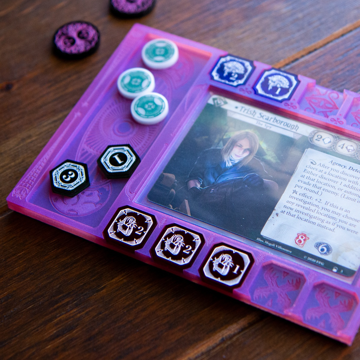 Dream Mythos Board with the Clue/Resource holder on the left side demonstrating its usability in both right and left handed positions.  A few tokens from the Investigator Mythos Set are slotted in there places and the Arkham Horror LCG investigator, Trish Scarborough is resting in the card holder section