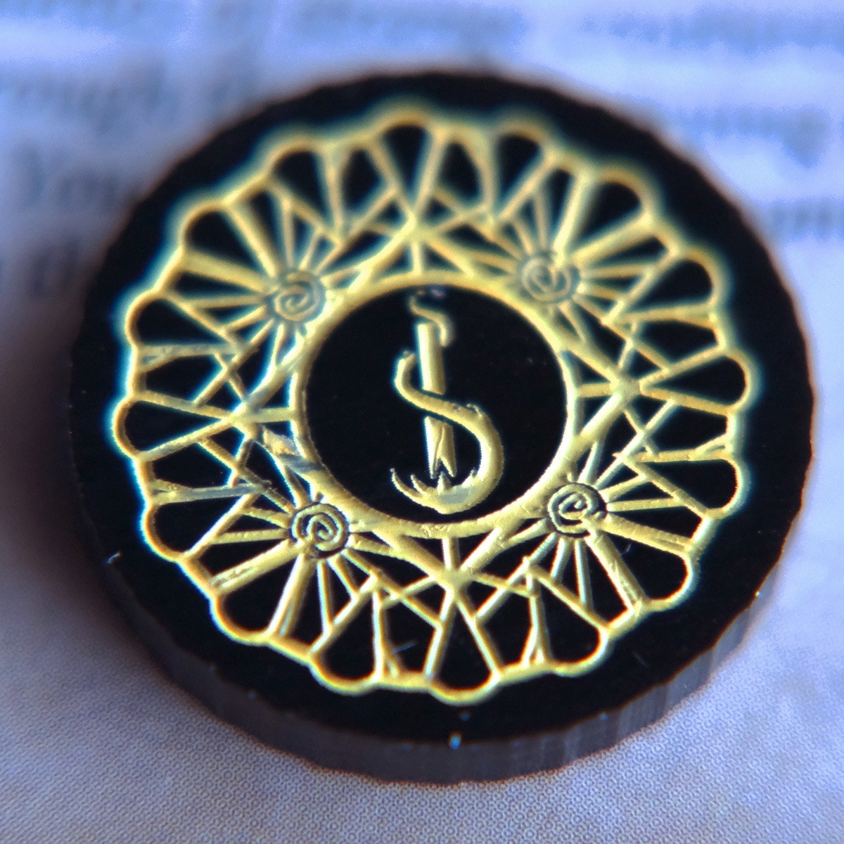 Close up of the one-value side of the Carcosa Limited Edition Doom Token highlighting the inverted torch motif