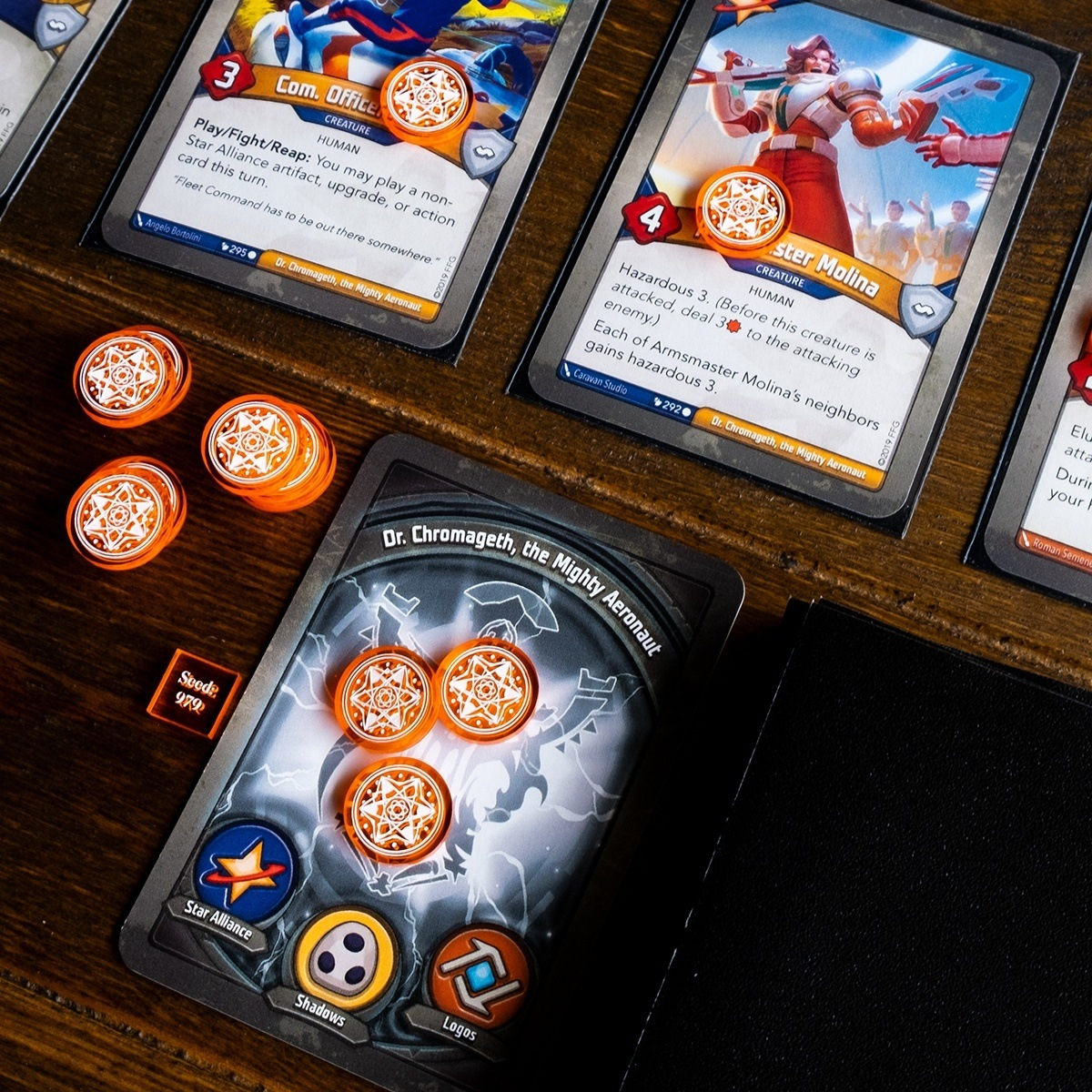 Unique Amber tokens generated by the seed number 979 adorn Keyforge cards, some are stacked next to an Archon card