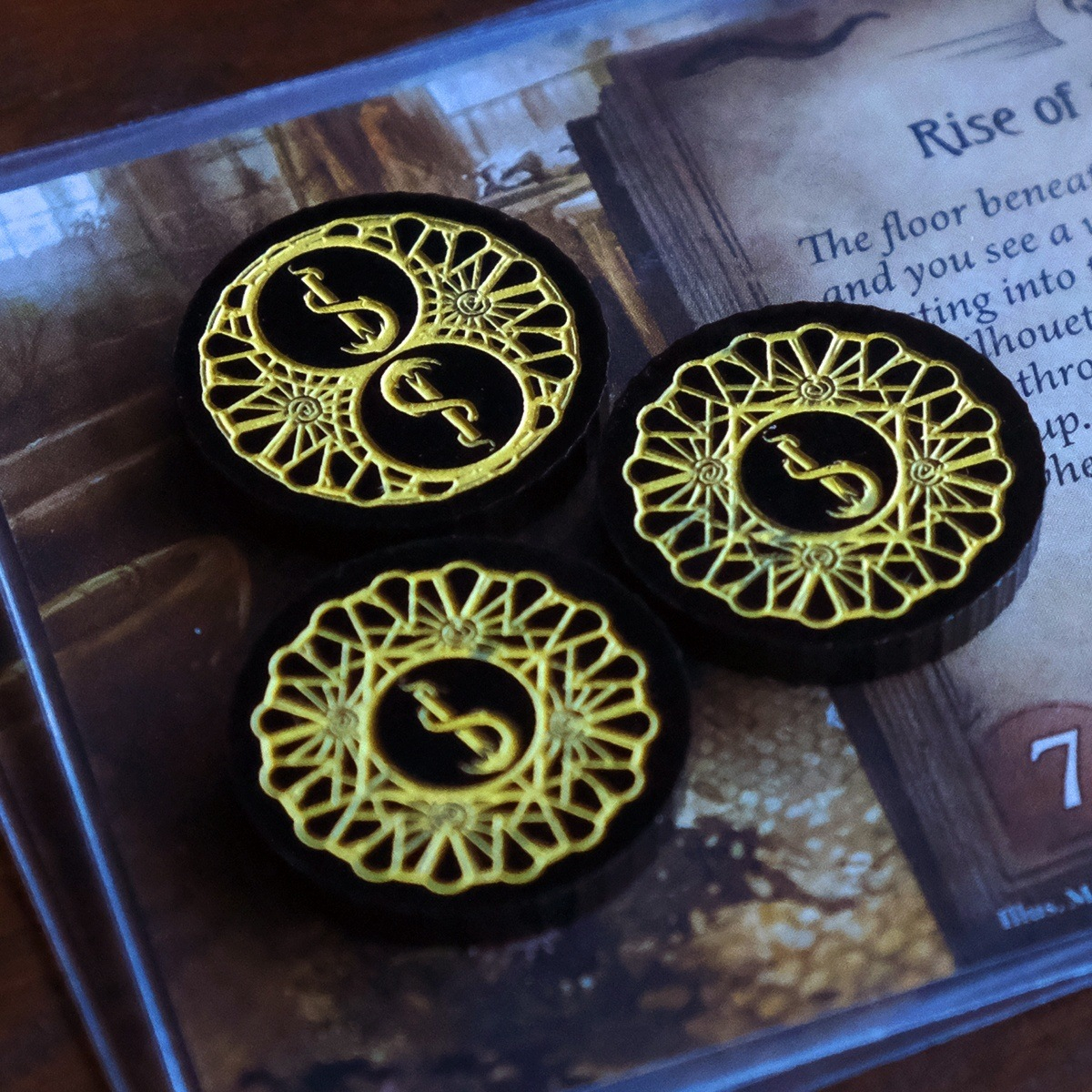 One two-value and two one-value Carcosa Limited Edition Doom tokens on the Arkham Horror LCG card, Rise of the Ghouls
