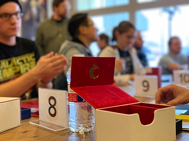 A deckbox with a Covenant Phoenix during a tournament at Covenant.