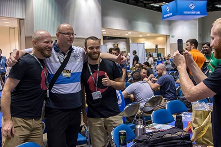 Jonathan and Robert posing for a photo with someone at GenCon.