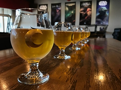 A row of drink glasses with the Covenant phoenix printed on them.