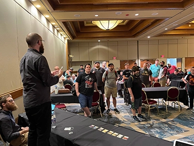 Raphe addressing tournament participants during a Covenant-hosted event.