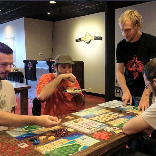 A group playing a board game at Covenant.