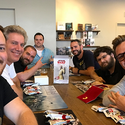 A group of people playing Star Wars Destiny at Covenant.
